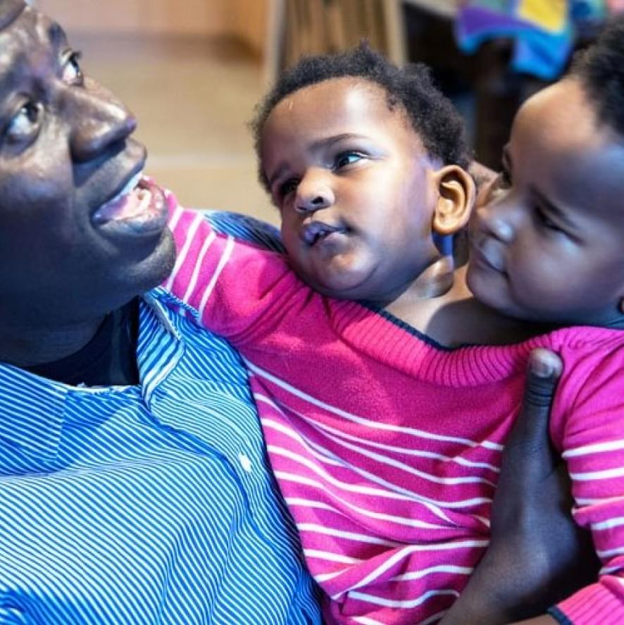 Conjoined twins Marieme and Ndeye pictured in the arms of their dad Ibrahima.